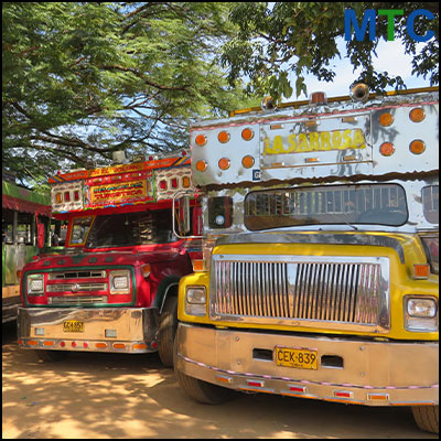 Two parked buses one red and one yellow